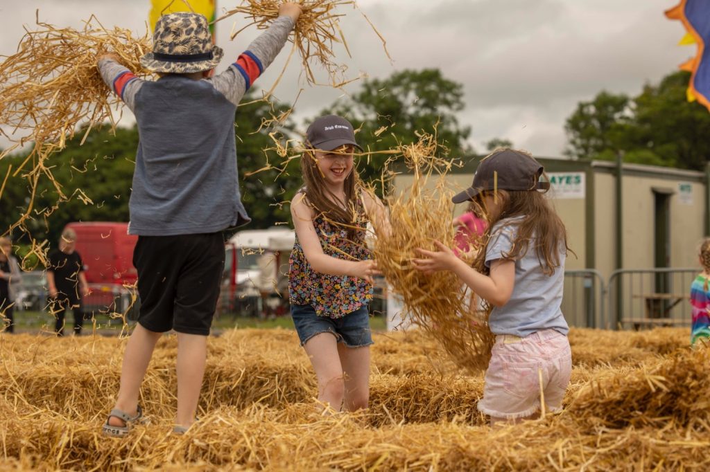 Children playing with straw bales at the Cork Summer Show